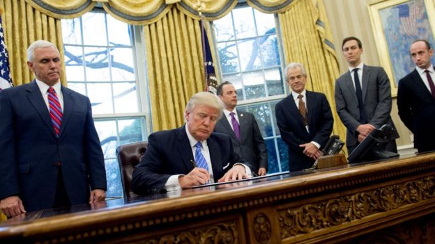 US President Donald Trump signing an abortion-related order in the Oval Office