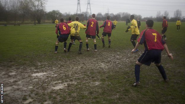 Local amateur football is played on a muddy football pitch at Hackney Marshes