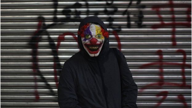 A protester wearing a scary clown mask poses during a rally in Tsuen Wan district in Hong Kong on October 1, 2019,