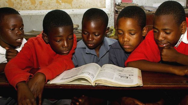 Children reading from a textbook in Harare, Zimbabwe - 2009