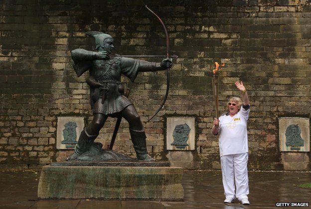 Olympic torchbearer Barbara Green poses with the Robin Hood statue