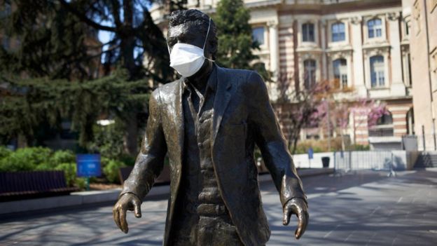 A facemask on a statue of well known singer Claude Nougaro in Toulouse in early April