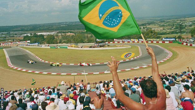 An Ayrton Senna fan waves a flag of the driver's nation Brazil at the South African Grand Prix of 1993