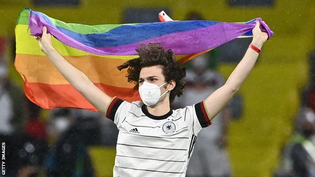 A spectator wearing a German shirt ran onto the pitch with a rainbow flag during the Hungarian anthem