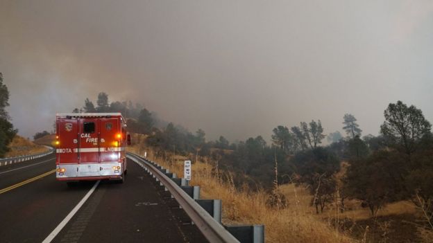 Fire truck approaching smoky forests