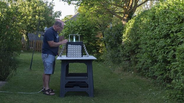 Paul Rule in garden setting up moth trap