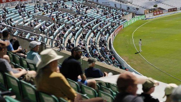 Spectators watch cricket