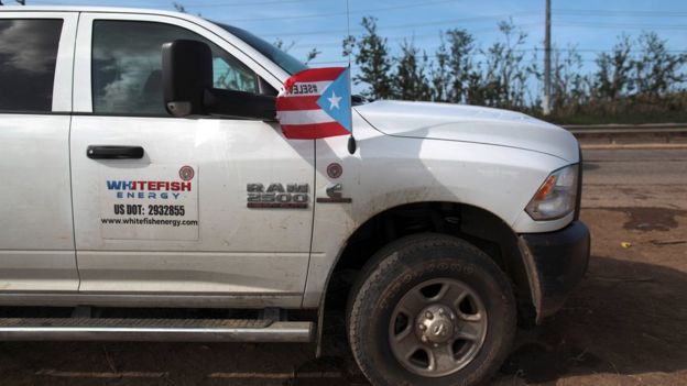 A truck with Whitefish Energy's logo and a Puerto Rican flag