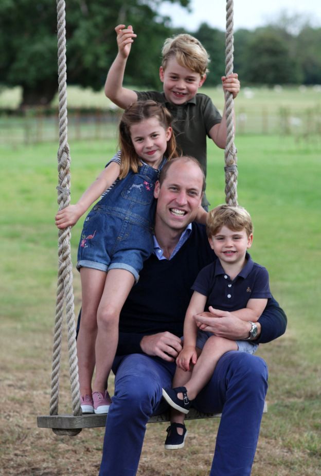 The Duke of Cambridge poses on a swing with Prince George, Princess Charlotte and Prince Louis