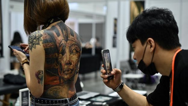 Woman with a tattoo on her exposed back