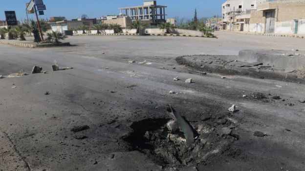 Crater in a road after a suspected chemical attack in Khan Sheikhoun, Idlib province, Syria (4 April 2017)