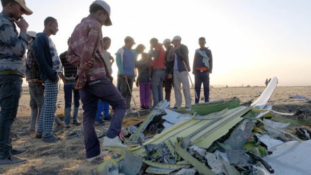 People gather at the Ethiopian Airline crash site