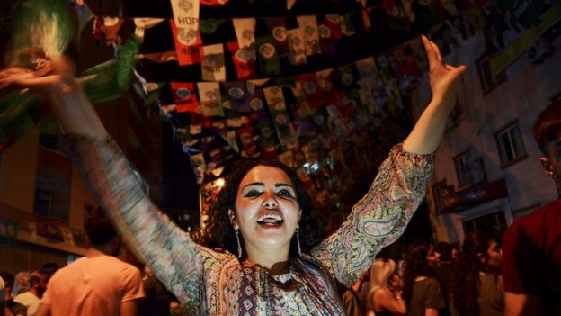 Women dance under election banners of the HDP in the mainly-Kurdish city of Diyarbakir