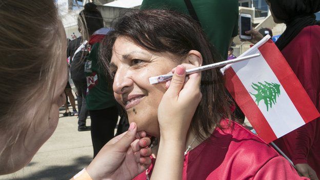 A Lebanon fan gets ready for their match against France
