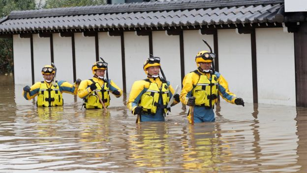 Police search a flooded area in the aftermath of Typhoon Hagibis,