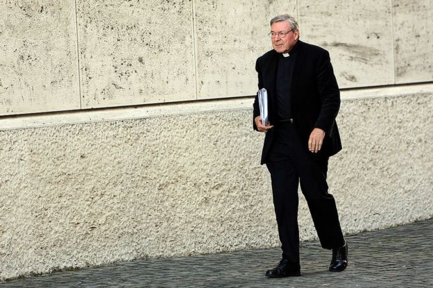Cardinal George Pell walks in Vatican City