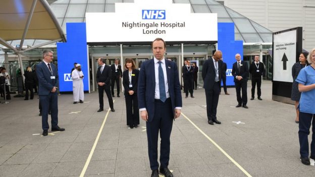 Health Secretary Matt Hancock and NHS staff stand on marks on the ground, put in place to ensure social distancing guidelines are adhered to, at the opening of the NHS Nightingale Hospital at the ExCel centre in London