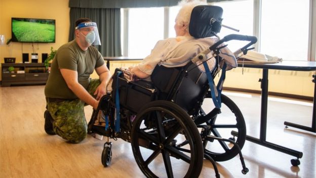 A Canadian soldier aids a senior citizen at a long-term care centre in Montreal, Quebec on 10 May