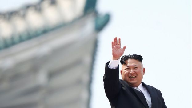 North Korean leader Kim Jong-un waves to people attending a military parade marking the 105th birth anniversary of country's founding father, Kim Il Sung in Pyongyang, on 15 April