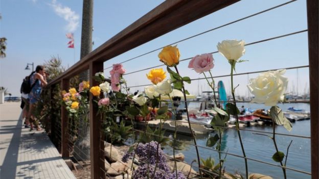 Flowers left at the dock in Santa Barbara after fire engulfed a diving vessel