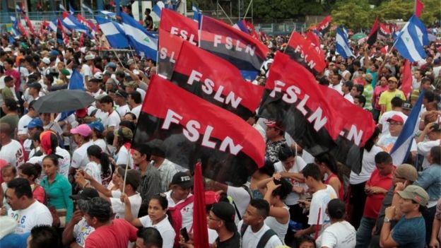 Supporters of Nicaragua's President Daniel Ortega hold up sandinista flag during the celebrations for the 37th anniversary of the 