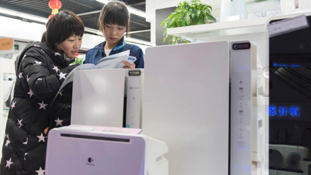 Shoppers look at air purifiers in Beijing