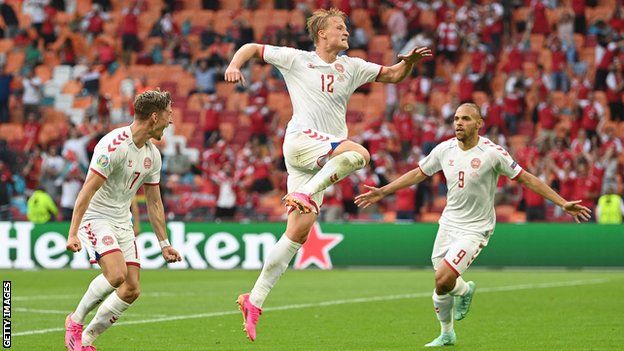 Kasper Dolberg (centre) leads Denmark's celebrations after his second goal of the game