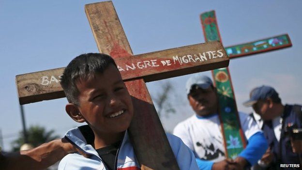 Migrants arrive at the Basilica of the Virgin of Guadalupe while holding crosses during an annual human rights protest in Mexico City on 18 April, 2015