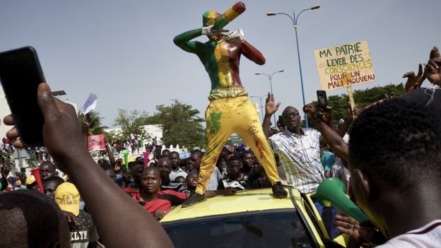 A man painted in the colours of Malian flag gestures at Independance square as protesters gather to demand that Malian President Ibrahim Boubacar Keïta leaves office in Bamako on June 19, 2020