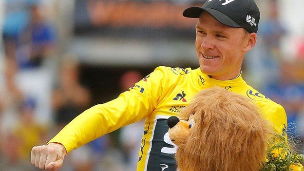 Chris Froome celebrates on the podium at the end of stage 20