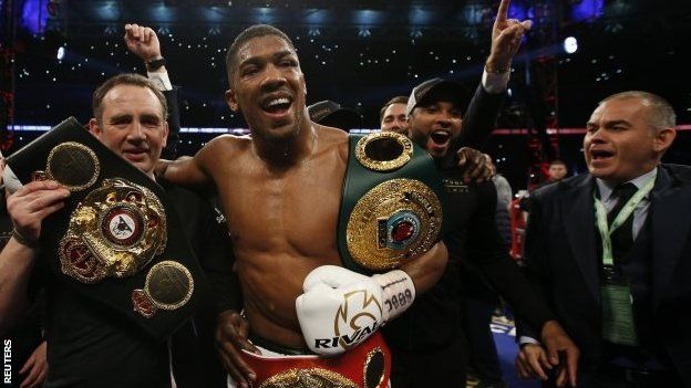 Anthony Joshua with his world title belts
