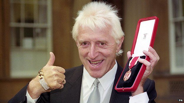 Jimmy Savile with his knighthood in 1990