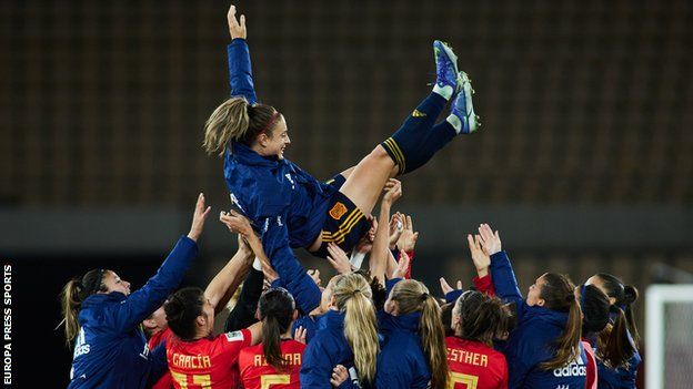 Putellas is lifted up by her Spanish team-mates