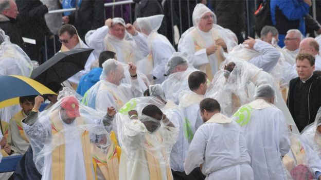 Clergy shelter from rain ahead of Holy Mass at Phoenix Park, Dublin
