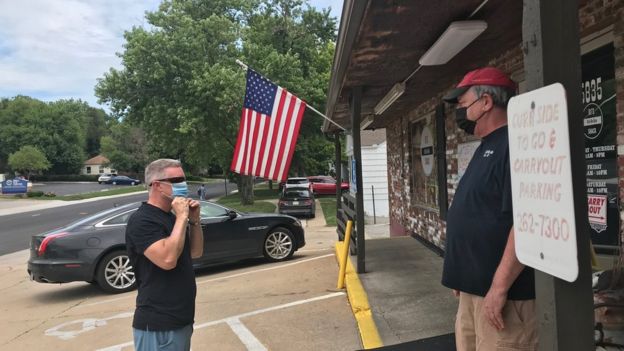 Bob Palmgren, the owner of RJ’s Bob-Be-Que Shack, tells a customer to put on a mask
