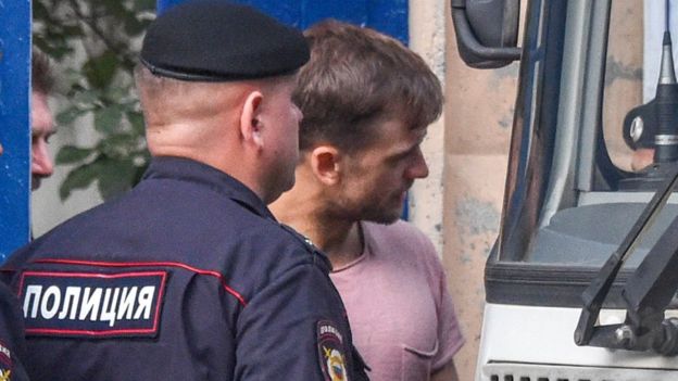 The Pussy Riot punk group member Pyotr Verzilov (R) leaves a detention centre in Moscow on July 30, 2018