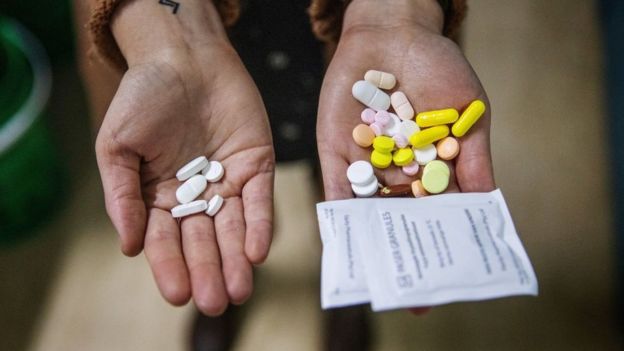 Dos manos con pastillas. A la izquierda solo unas cuantas, a la derecha muchas más.