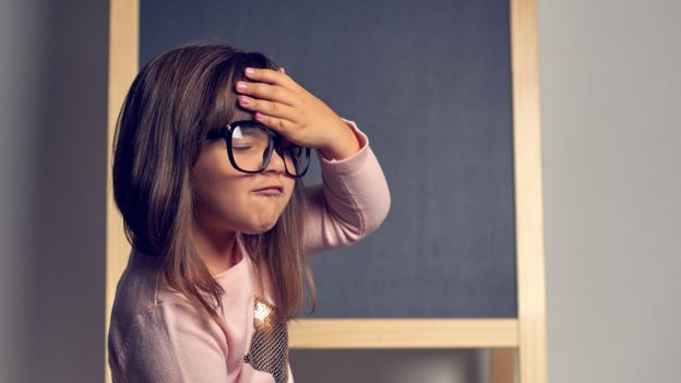 A child holds her head