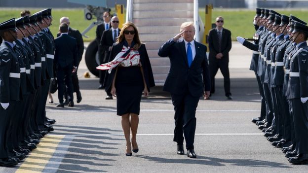 S President Donald J. Trump (R) salutes and First Lady Melania Trump (L) as they arrive at London Stansted Airport in Essex, Britain,