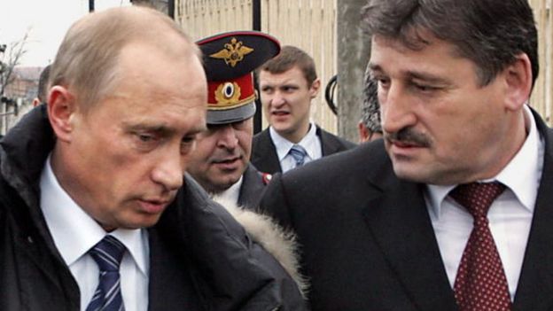Russian President Vladimir Putin speaks with Chechen President Alu Alkhanov prior the opening of the war-torn province's new parliament in Grozny, 12 December 2005