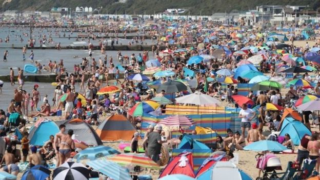 People enjoy the hot weather at Bournemouth beach in Dorset