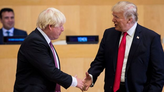 Boris Johnson (L) and US President Donald Trump greet before a meeting on United Nations Reform