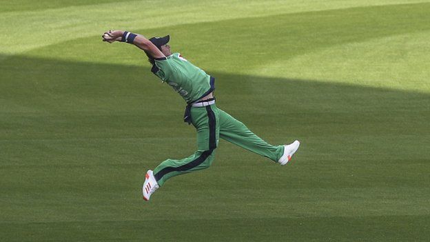 Ireland's Mark Adair at full stretch to take a superb catch to dismiss opener Javed Ahmadi
