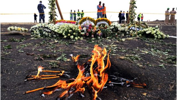 Candles burn during a commemoration ceremony for the victims at the scene of the Ethiopian Airlines Flight 302 plane crash, near Addis Ababa, Ethiopia