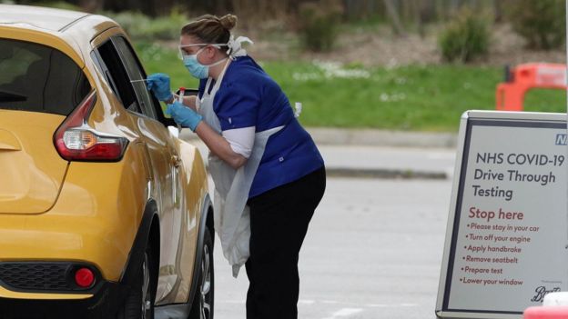 A person is tested at a drive-through coronavirus testing site at Chessington World of Adventures, in Greater London