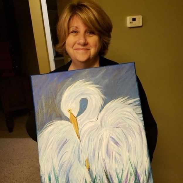 Cindi Decker with her painting of an egret