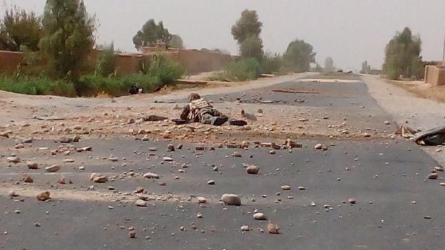 A soldier extracting an IED on the road to Nad Ali District