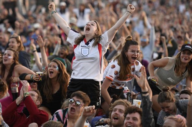 Football fans celebrate at Glastonbury