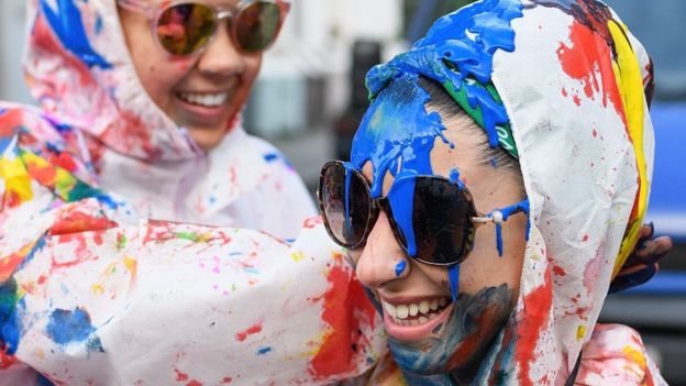 Paint-covered revellers take part in the traditional 