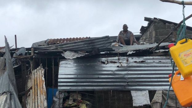 Man mending roof